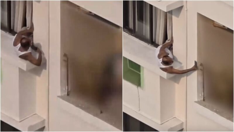 Man leans out of high-rise balcony to record neighbour’s flat, people demand action