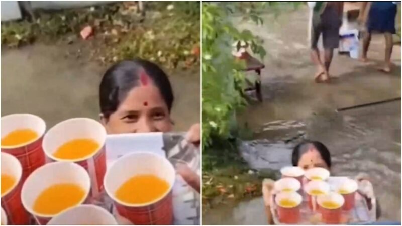 Assam woman serves juice to relief workers while standing in waist-deep floodwater